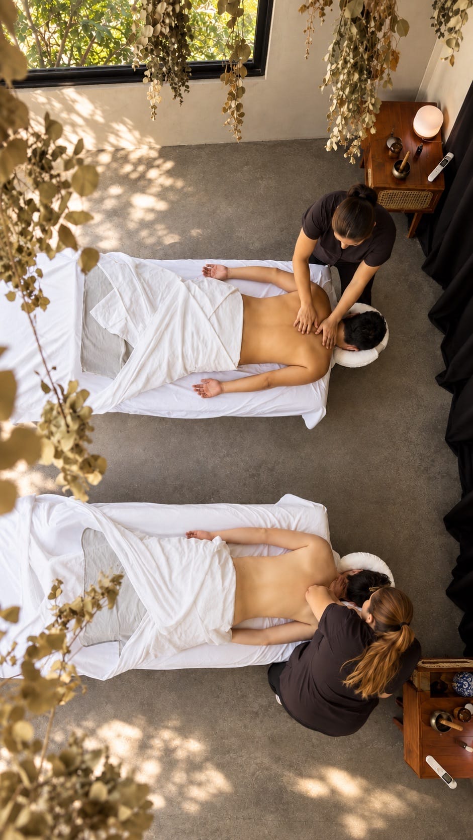 Two therapists giving a couples massage at Casa Botica, seen from above