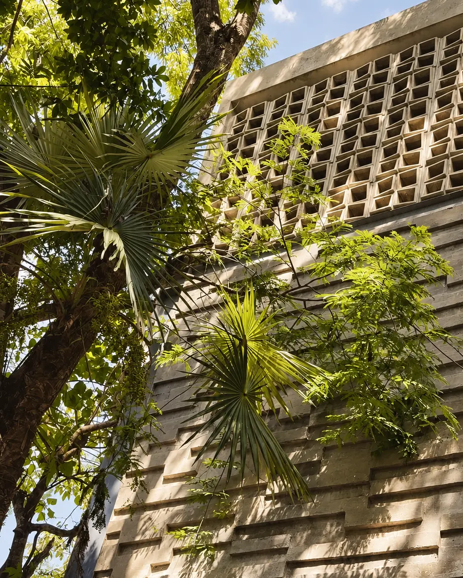 Stone facade of Casa Botica private spa among palms in Playa del Carmen