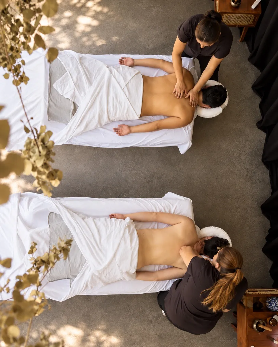 Two therapists giving a couples massage at Casa Botica spa in Playa del Carmen, seen from above