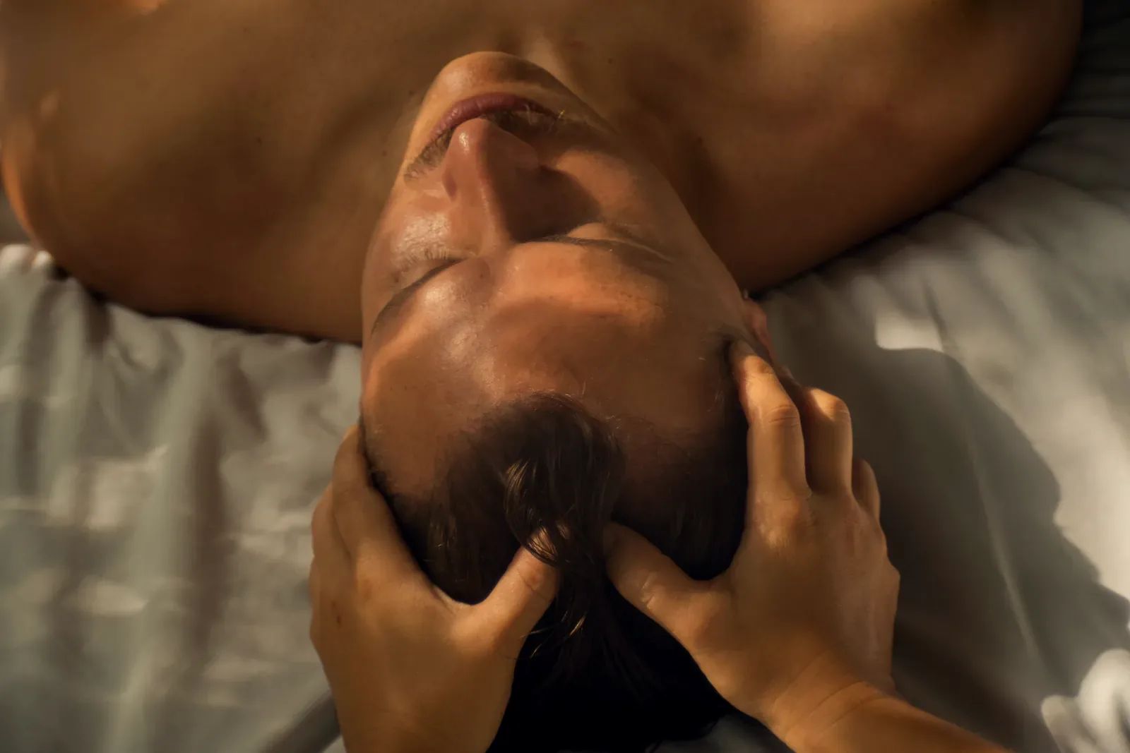 Therapist giving a head massage during an in-home massage in Playa del Carmen